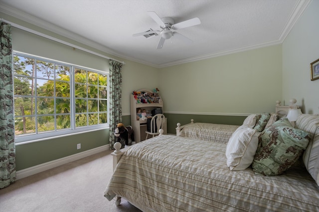 carpeted bedroom featuring baseboards, ceiling fan, and crown molding