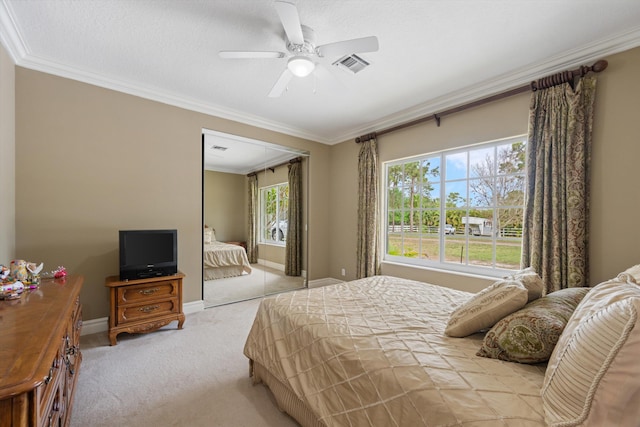 bedroom featuring baseboards, visible vents, ornamental molding, and light colored carpet