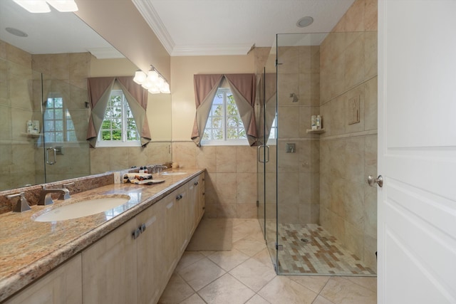 full bathroom featuring a wealth of natural light, crown molding, tile walls, and a sink