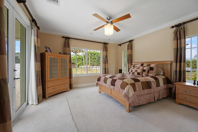 bedroom with light carpet, crown molding, visible vents, and multiple windows