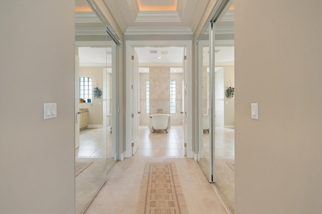 hall featuring light carpet, ornamental molding, light tile patterned floors, and visible vents