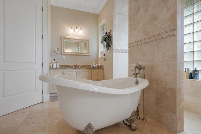 full bathroom with a freestanding tub, tile patterned flooring, a sink, tile walls, and crown molding