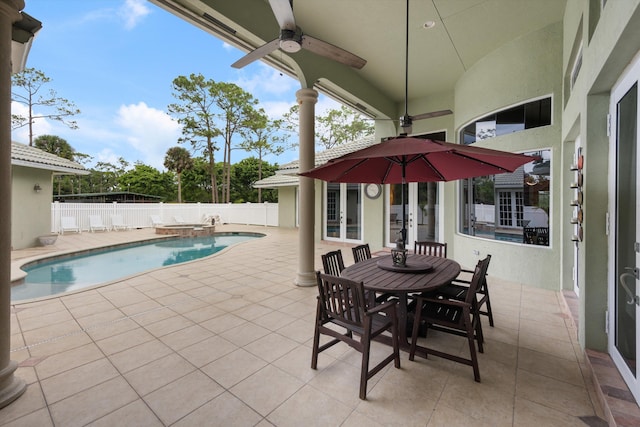 view of patio / terrace with a ceiling fan, a pool with connected hot tub, and a fenced backyard