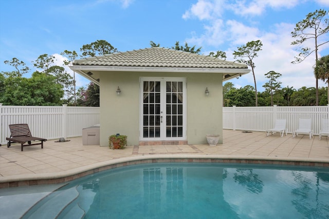 back of house featuring stucco siding, fence, a patio, and a tiled roof