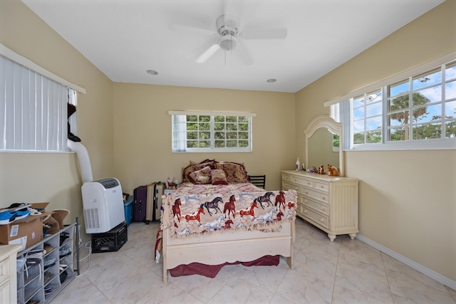 bedroom with ceiling fan and baseboards