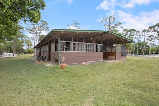 rear view of property featuring an exterior structure and an outdoor structure