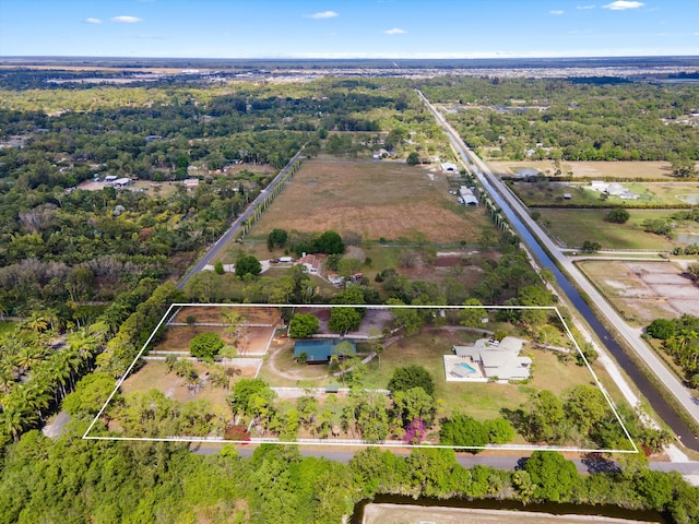 drone / aerial view with a wooded view