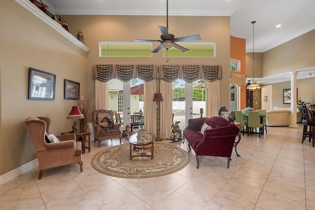 interior space with ornamental molding, a high ceiling, and ornate columns