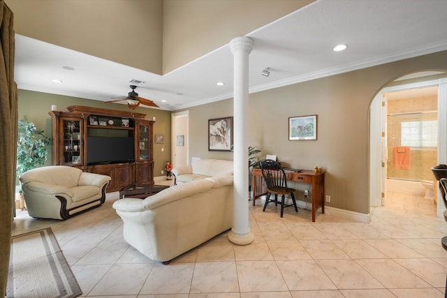 living room featuring arched walkways, ceiling fan, light tile patterned flooring, ornamental molding, and decorative columns