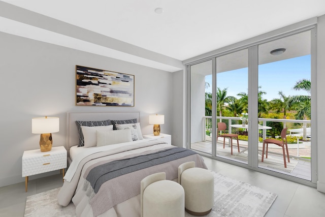 bedroom featuring a wall of windows and access to exterior