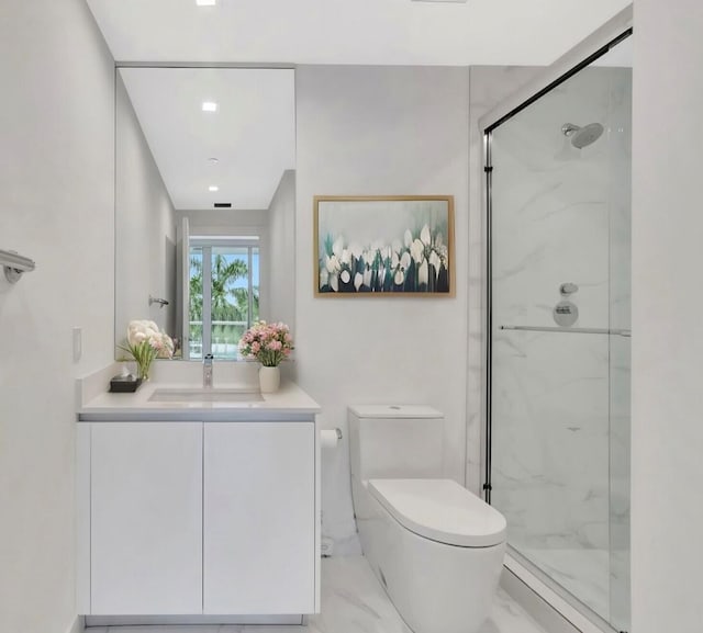 bathroom featuring marble finish floor, vanity, a marble finish shower, and toilet