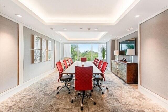 dining room featuring recessed lighting, baseboards, a raised ceiling, and light colored carpet