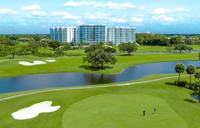 view of property's community featuring view of golf course and a water view