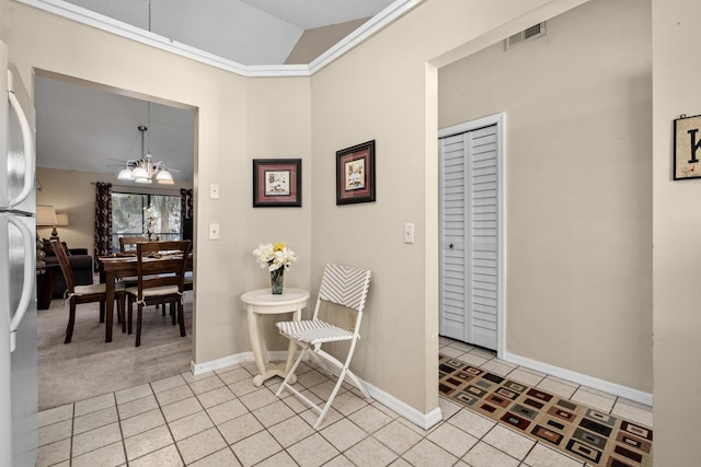 interior space with light tile patterned flooring, vaulted ceiling, visible vents, and a notable chandelier