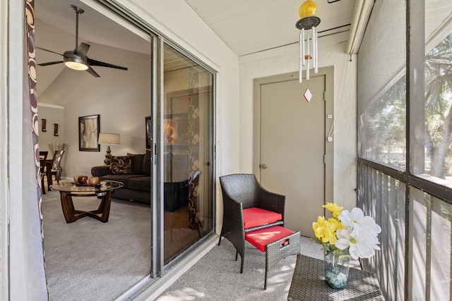 sunroom featuring lofted ceiling, a wealth of natural light, and a ceiling fan