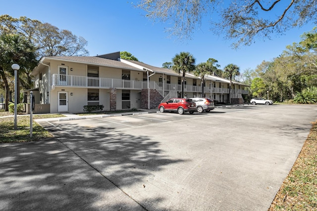 view of building exterior featuring uncovered parking