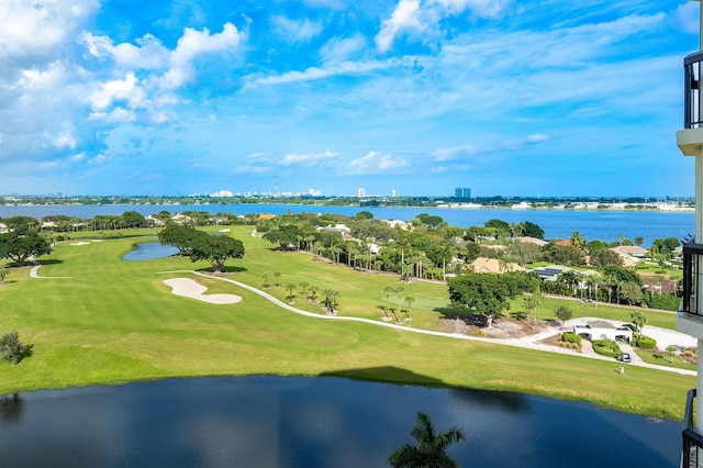 drone / aerial view featuring view of golf course and a water view