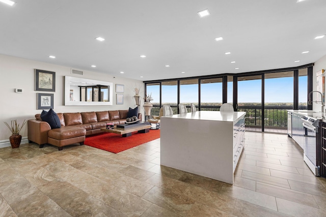 living area featuring recessed lighting, visible vents, and floor to ceiling windows