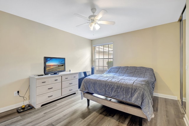 bedroom with baseboards, ceiling fan, and light wood finished floors