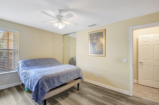 bedroom with wood finished floors and baseboards