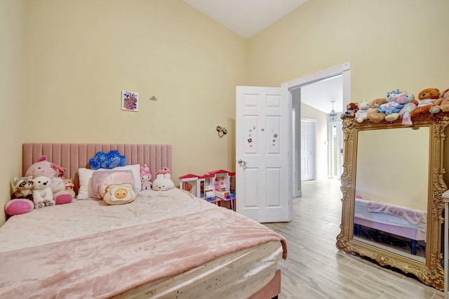 bedroom featuring lofted ceiling and light wood finished floors