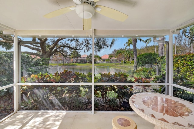 unfurnished sunroom featuring ceiling fan