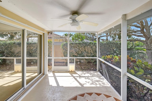 unfurnished sunroom with a ceiling fan