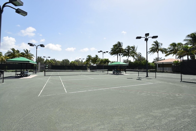 view of sport court featuring fence