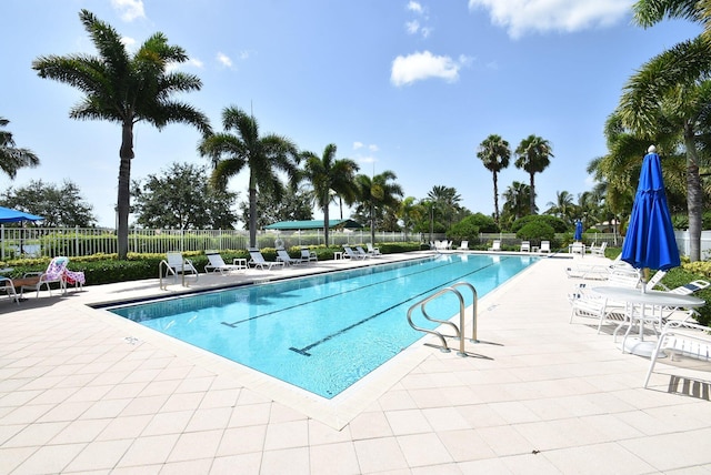 pool featuring a patio area and fence