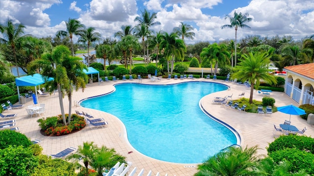 community pool featuring fence and a patio