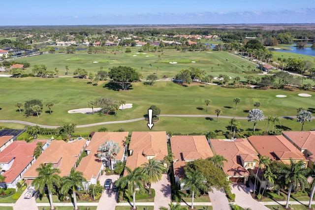 aerial view with a residential view, view of golf course, and a water view