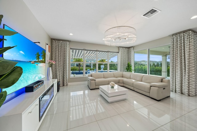 living room with visible vents, a notable chandelier, a textured ceiling, and light tile patterned floors