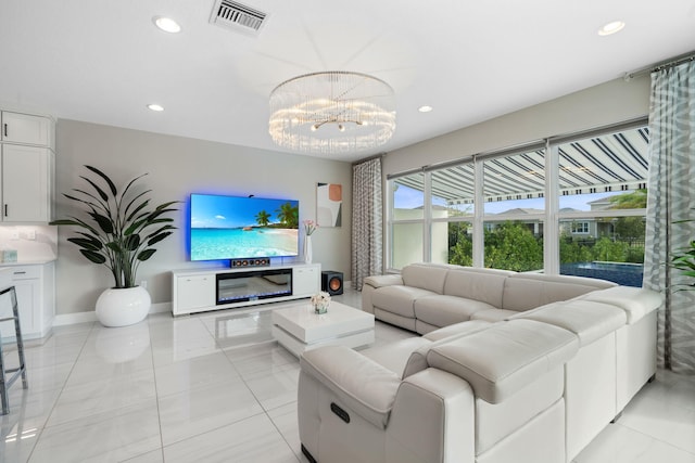 living room with a chandelier, recessed lighting, visible vents, and baseboards