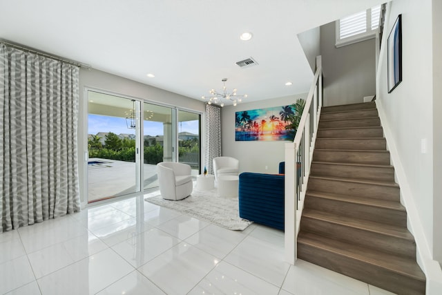 interior space with a chandelier, recessed lighting, visible vents, and baseboards