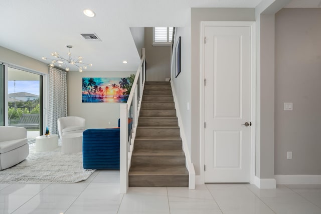 stairway with baseboards, visible vents, a chandelier, and recessed lighting