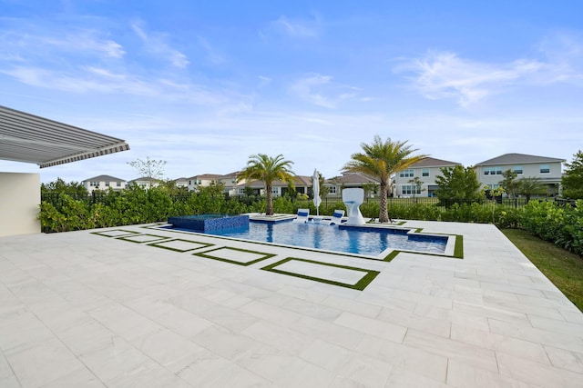 view of swimming pool with a residential view, a pool with connected hot tub, a patio, and fence