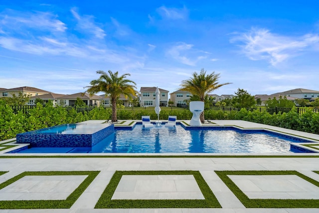 view of pool featuring a fenced in pool, a residential view, fence, and an in ground hot tub