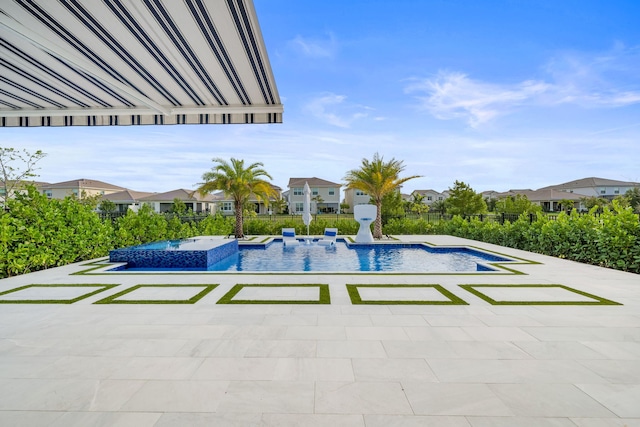 view of pool with a patio, a pool with connected hot tub, and a residential view