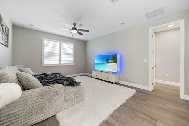 bedroom featuring light wood-type flooring, visible vents, ceiling fan, and baseboards