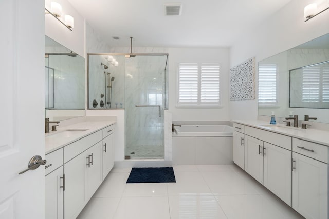 bathroom with a stall shower, tile patterned flooring, a sink, and a bath