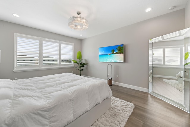 bedroom featuring recessed lighting, dark wood finished floors, and baseboards