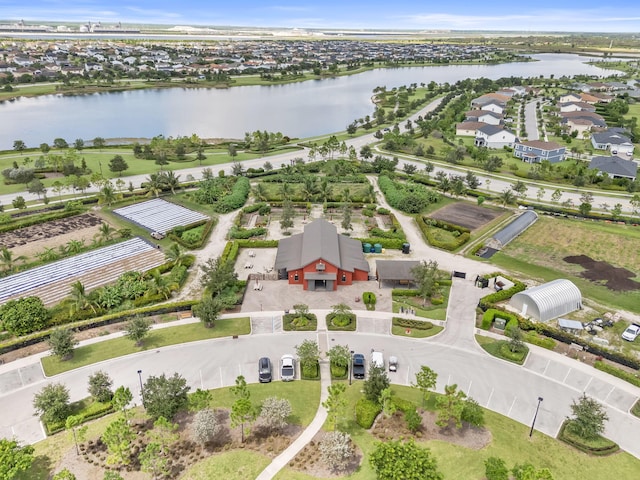 birds eye view of property featuring a water view and a residential view