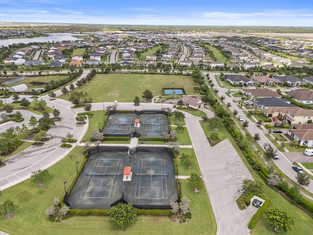 birds eye view of property with a water view and a residential view