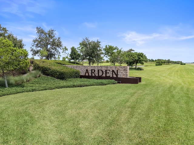 community sign featuring a lawn