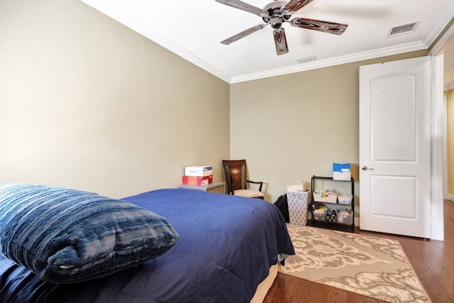 bedroom with ornamental molding, dark wood-type flooring, and visible vents