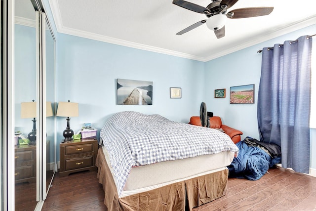 bedroom with ornamental molding, dark wood finished floors, and a closet