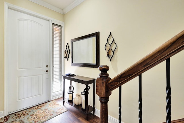 foyer featuring stairs, dark wood-type flooring, a healthy amount of sunlight, and crown molding