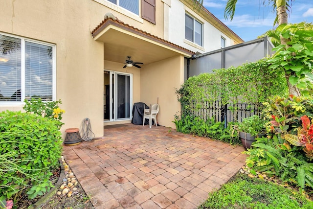 view of patio with fence and ceiling fan