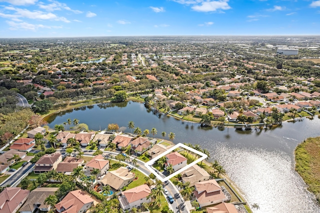 drone / aerial view featuring a water view and a residential view