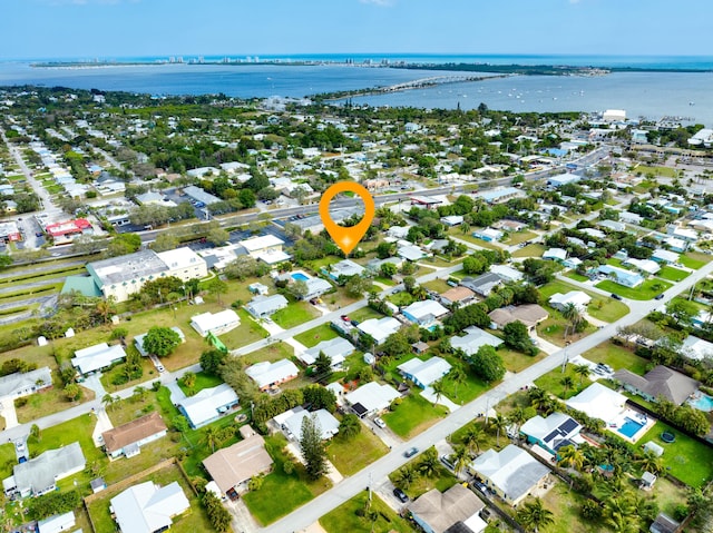 drone / aerial view featuring a residential view and a water view